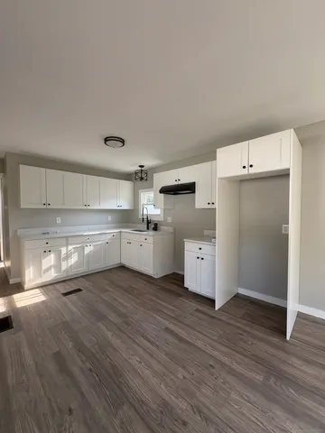 a view of cabinets and wooden floor