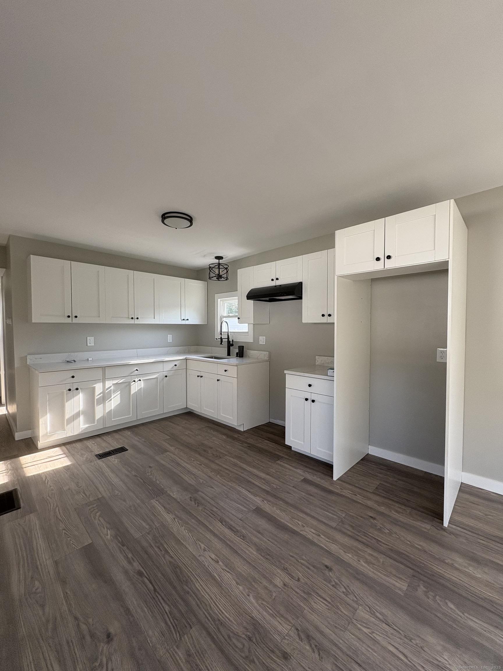 69 Nancy Lane Naugatuck, CT 06770 - Photo 4 of 10 a view of cabinets and wooden floor