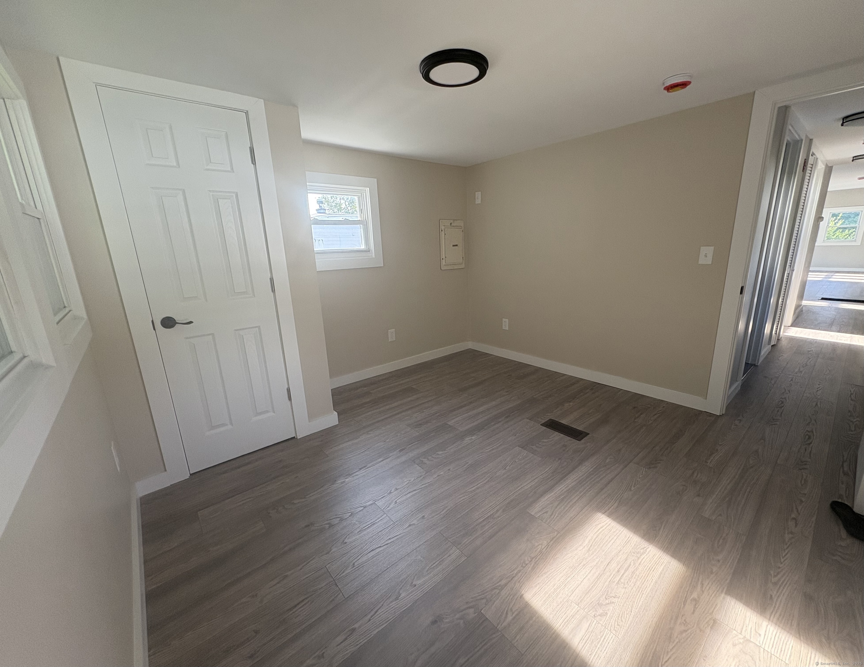69 Nancy Lane Naugatuck, CT 06770 - Photo 7 of 10 an empty room with wooden floor and window