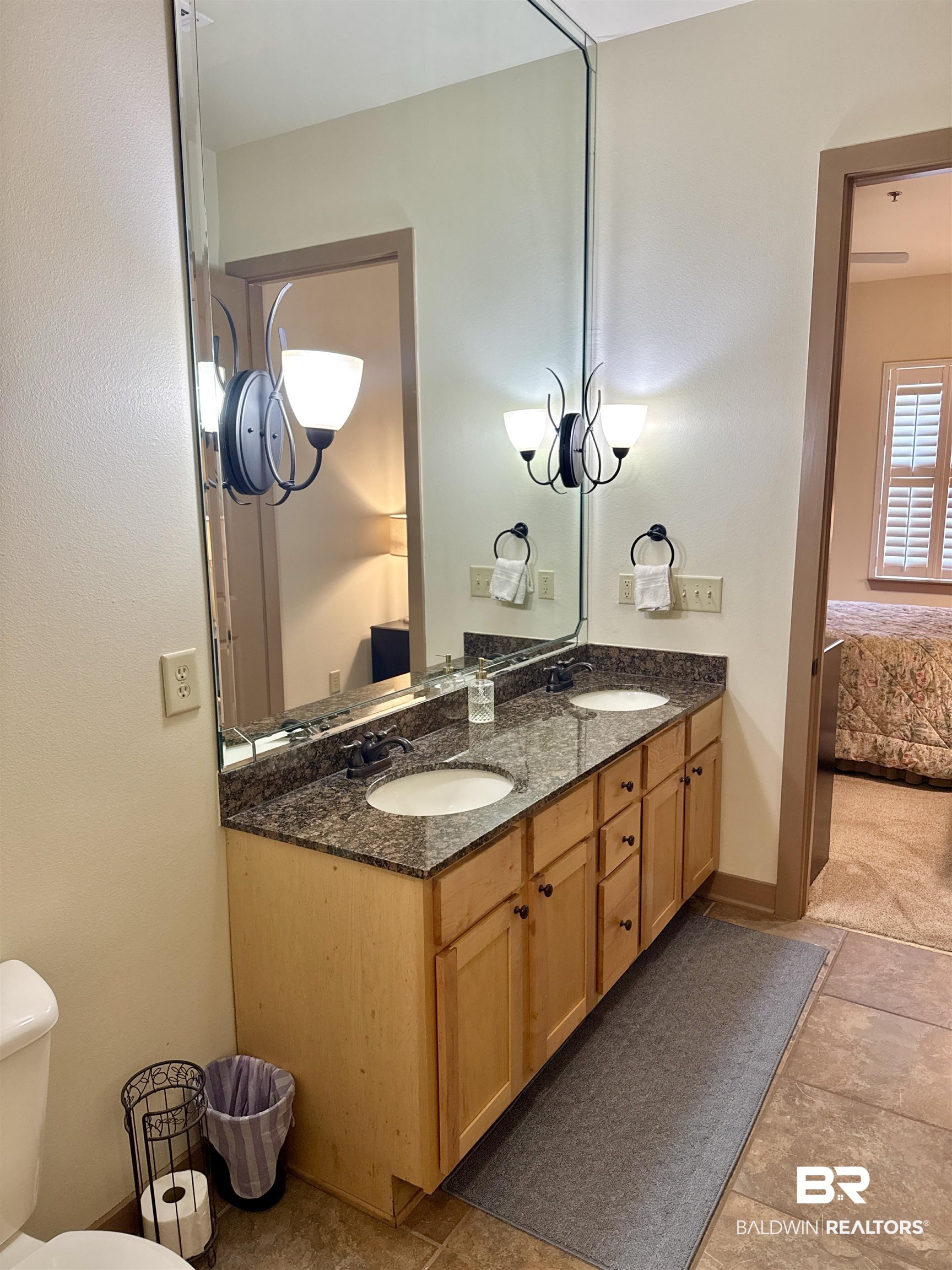 1430 Regency Road, Unit C101 Gulf Shores, AL 36542 - Photo 11 of 32 Ensuite bathroom with double vanity and toilet
