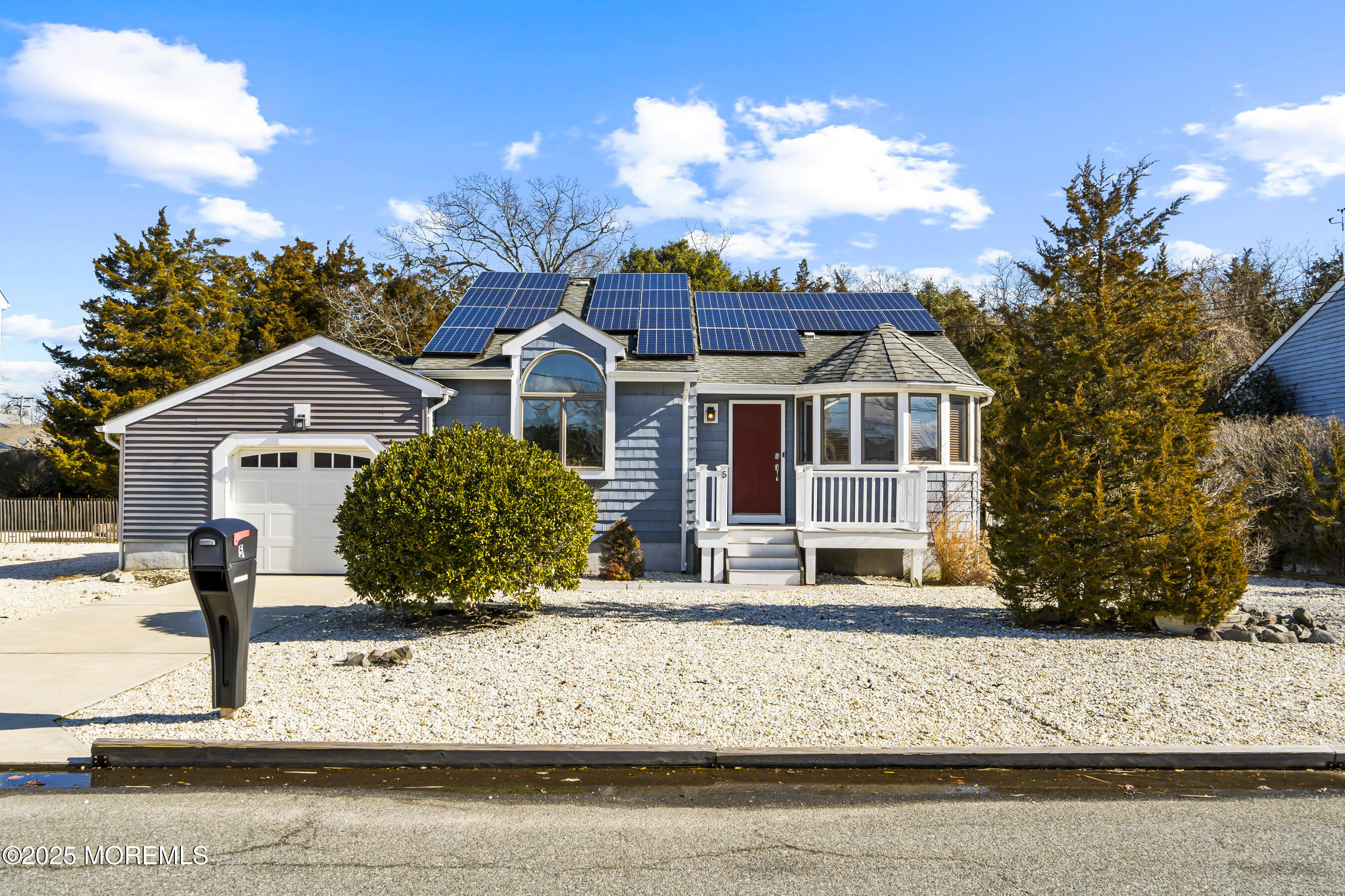 5 Beach Drive Little Egg Harbor, NJ 08087 - Photo 1 of 47 a front view of a house with a yard and garage