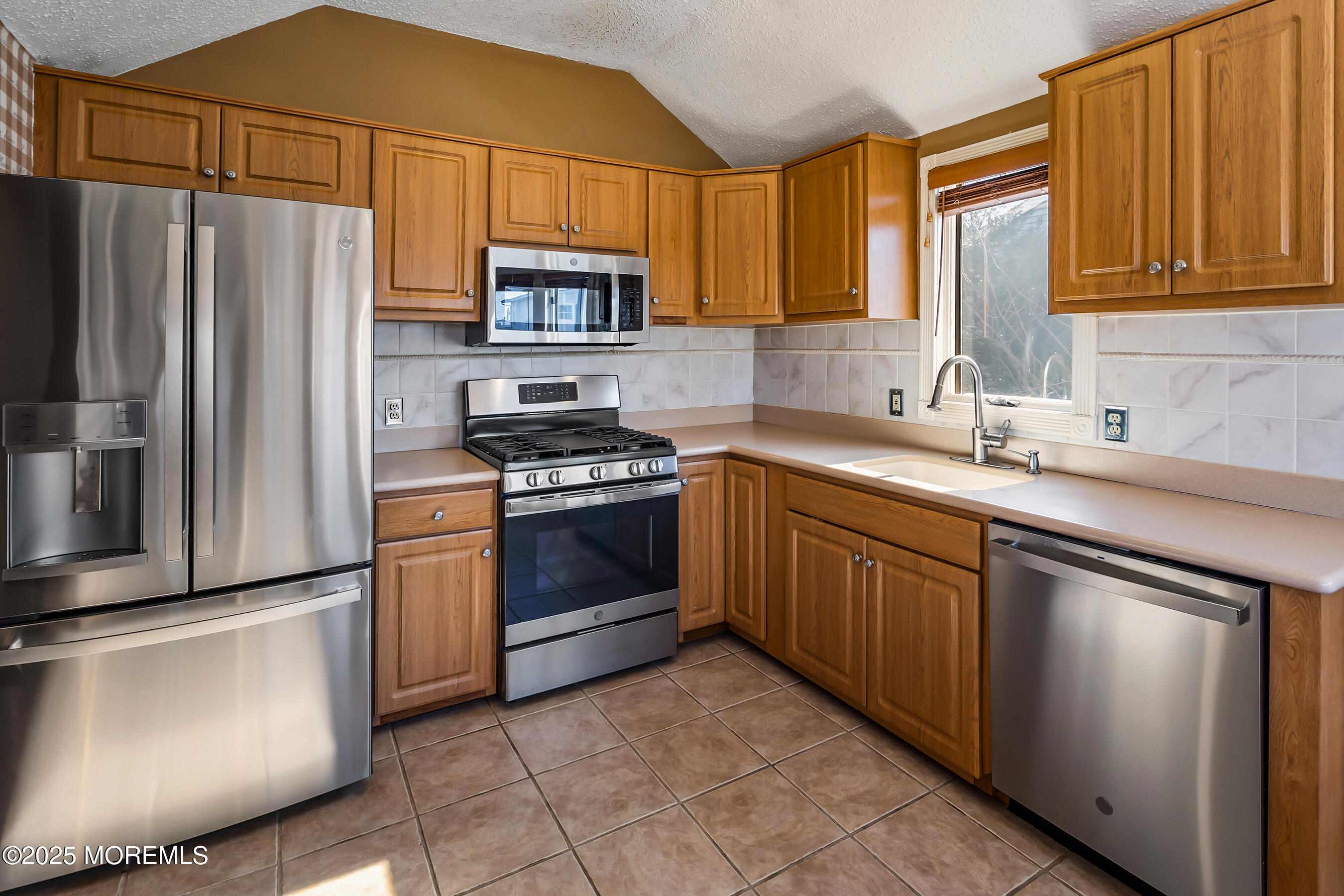 5 Beach Drive Little Egg Harbor, NJ 08087 - Photo 12 of 47 a kitchen with stainless steel appliances granite countertop a sink stove refrigerator and cabinets