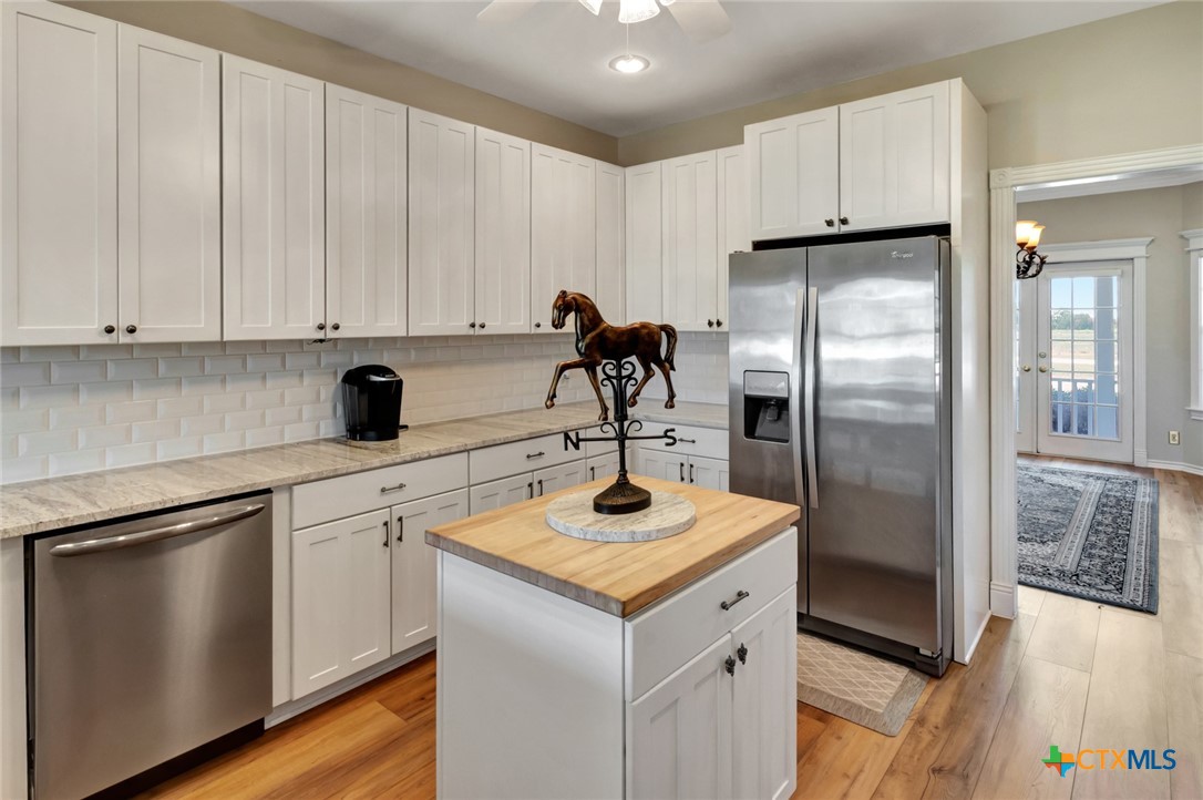 202 Prairie View Road Victoria, TX 77904 - Photo 13 of 47 a kitchen with a refrigerator sink and cabinets