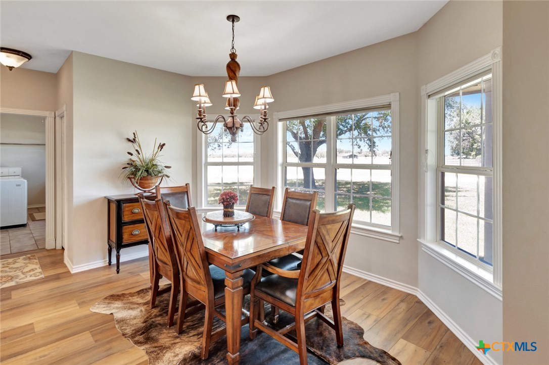 202 Prairie View Road Victoria, TX 77904 - Photo 14 of 47 a view of a dining room with furniture wooden floor and chandelier