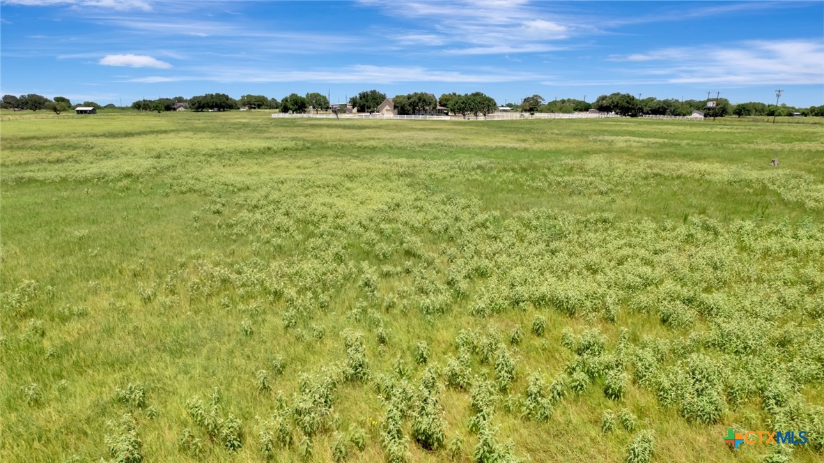 202 Prairie View Road Victoria, TX 77904 - Photo 34 of 47 a view of a field with an ocean and trees in the background