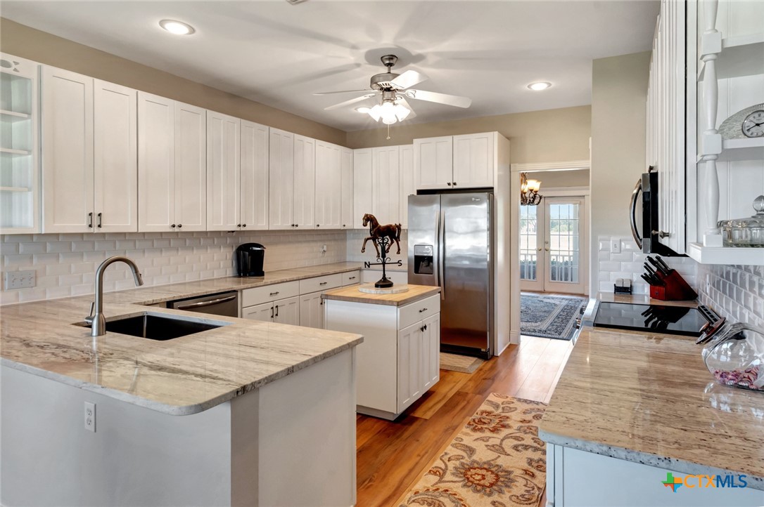 202 Prairie View Road Victoria, TX 77904 - Photo 10 of 47 a kitchen with stainless steel appliances granite countertop a sink refrigerator and cabinets
