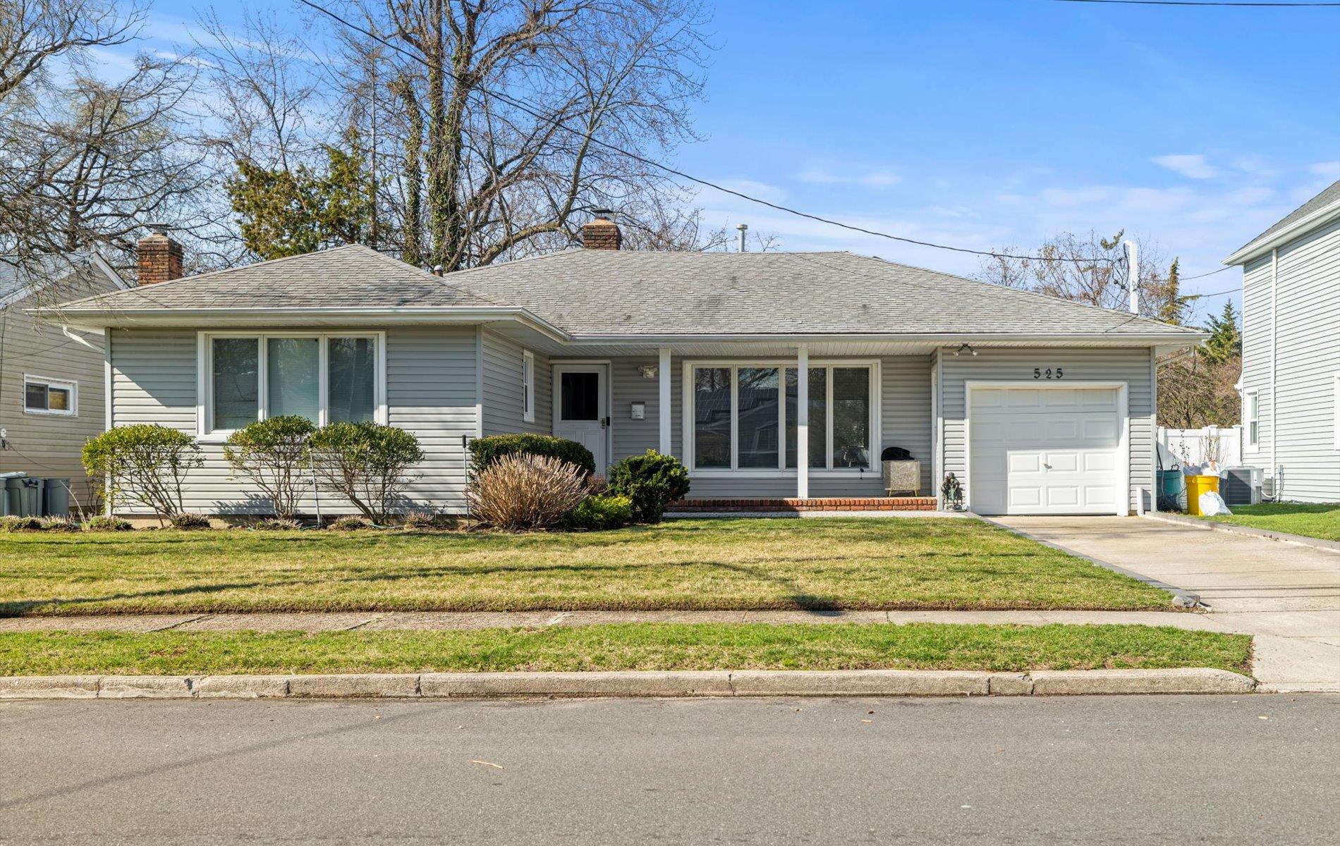 525 Allen Road Woodmere, NY 11598 - Photo 1 of 1 Ranch-style home featuring driveway, a front yard, a garage, and a chimney