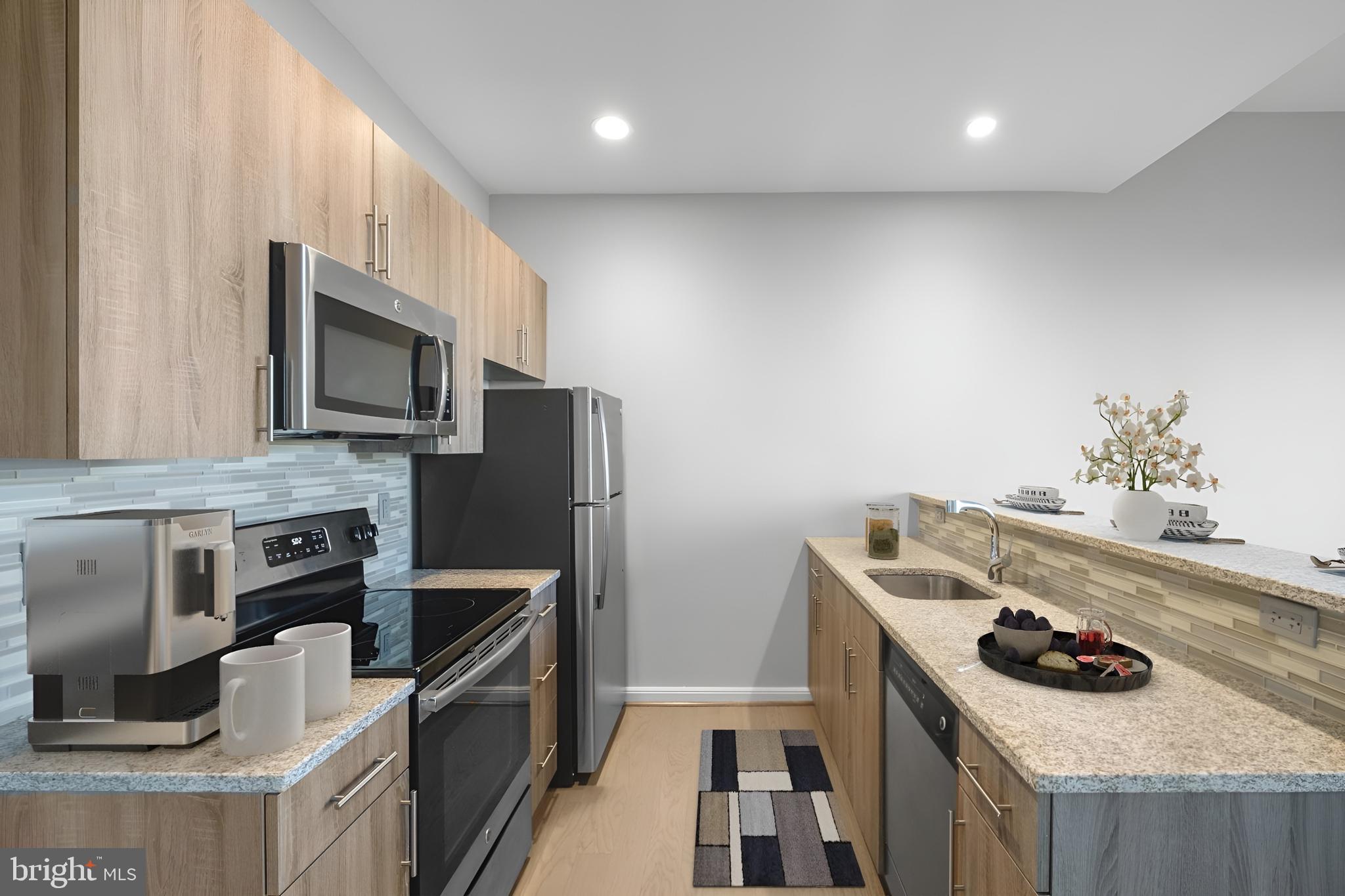 200 North 16th Street, Unit 1402 Philadelphia, PA 19102 - Photo 2 of 20 a kitchen with a stove and a microwave