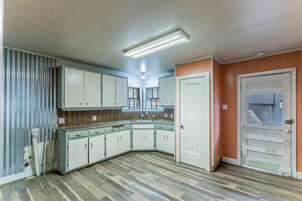 3320 Parrott Avenue Waco, TX 76707 - Photo 5 of 15 a kitchen with a sink cabinets and wooden floor