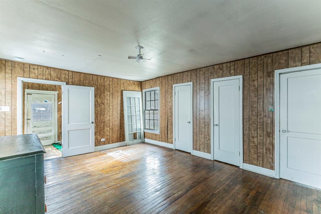 3320 Parrott Avenue Waco, TX 76707 - Photo 8 of 15 an empty room with wooden floor and windows