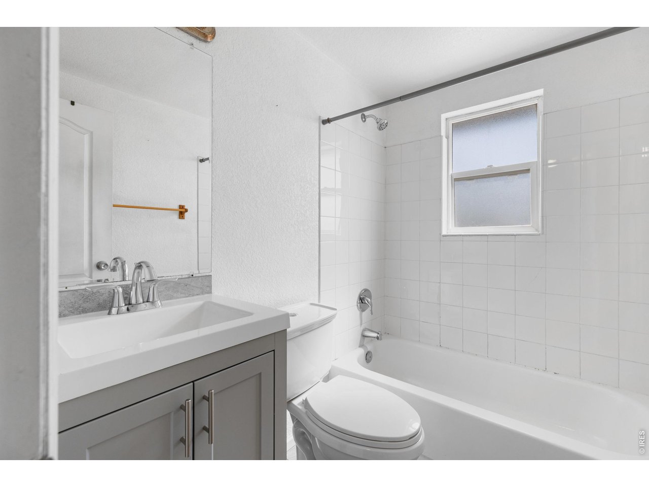 840 South Stuart Street Denver, CO 80219 - Photo 13 of 26 a bathroom with a sink mirror toilet and bathtub