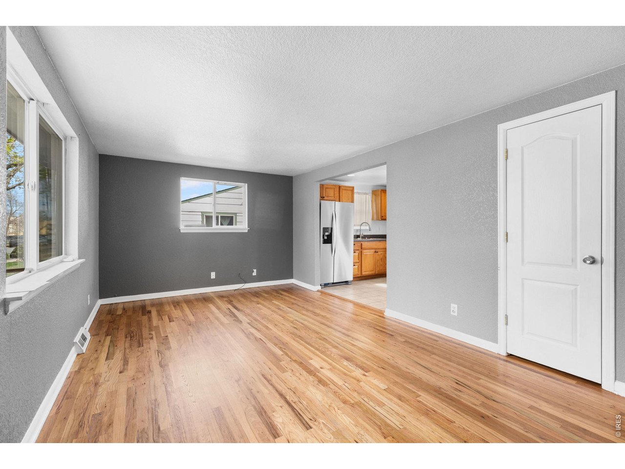 840 South Stuart Street Denver, CO 80219 - Photo 5 of 26 wooden floor in an empty room with a window