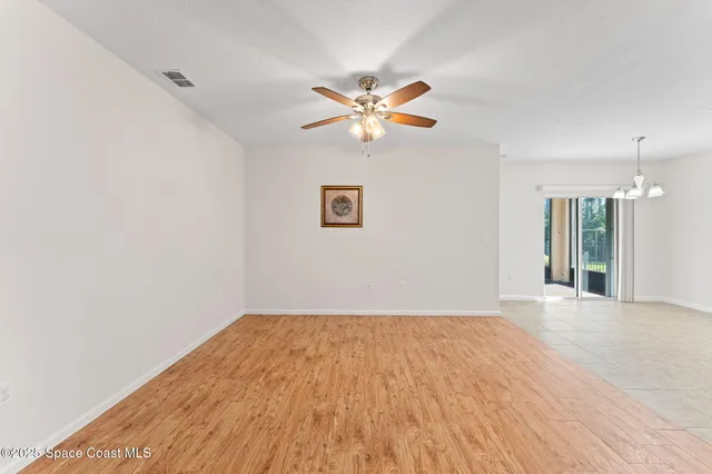 a view of kitchen with granite countertop cabinets and refrigerator