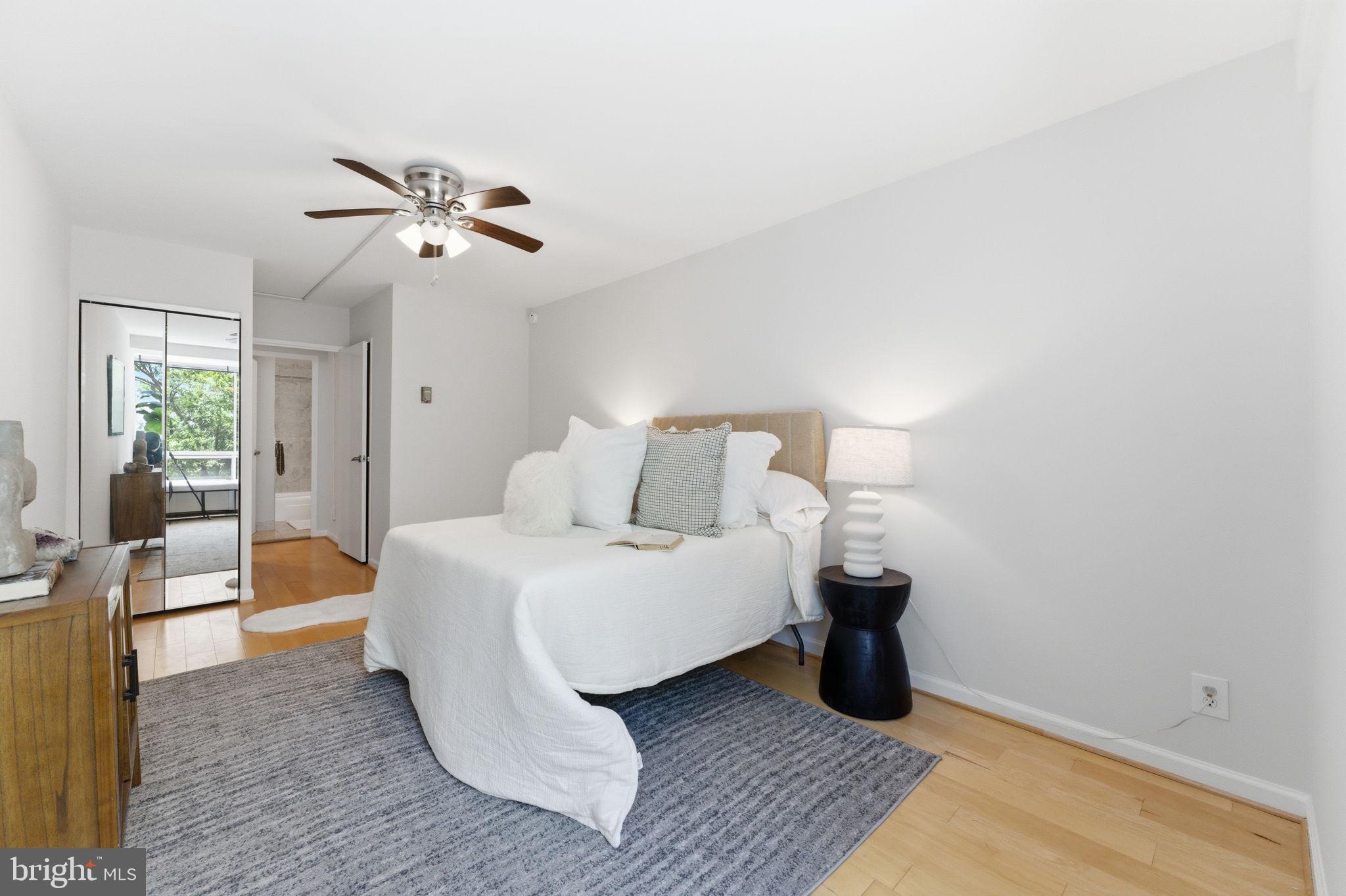 1435 4th Street Southwest, Unit B609 Washington, DC 20024 - Photo 28 of 52 a bedroom with a bed and wooden floor