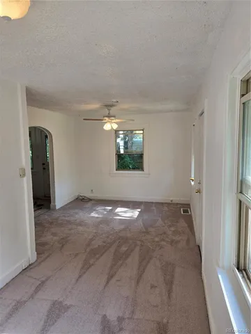 a view of a big room with windows and brick walls