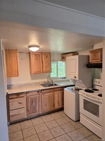 a kitchen with a stove sink and cabinets
