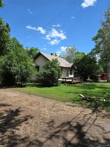 a green field with trees in front of it