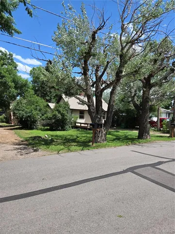 a view of a house with pool and a big yard