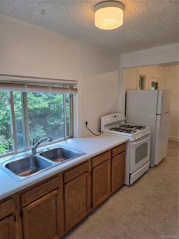 a kitchen with a sink and large window