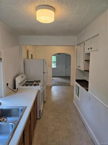 a kitchen with stainless steel appliances granite countertop a sink and a stove