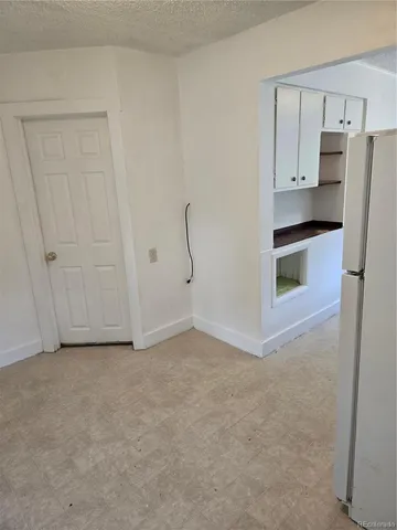 a view of an empty room with a cabinet