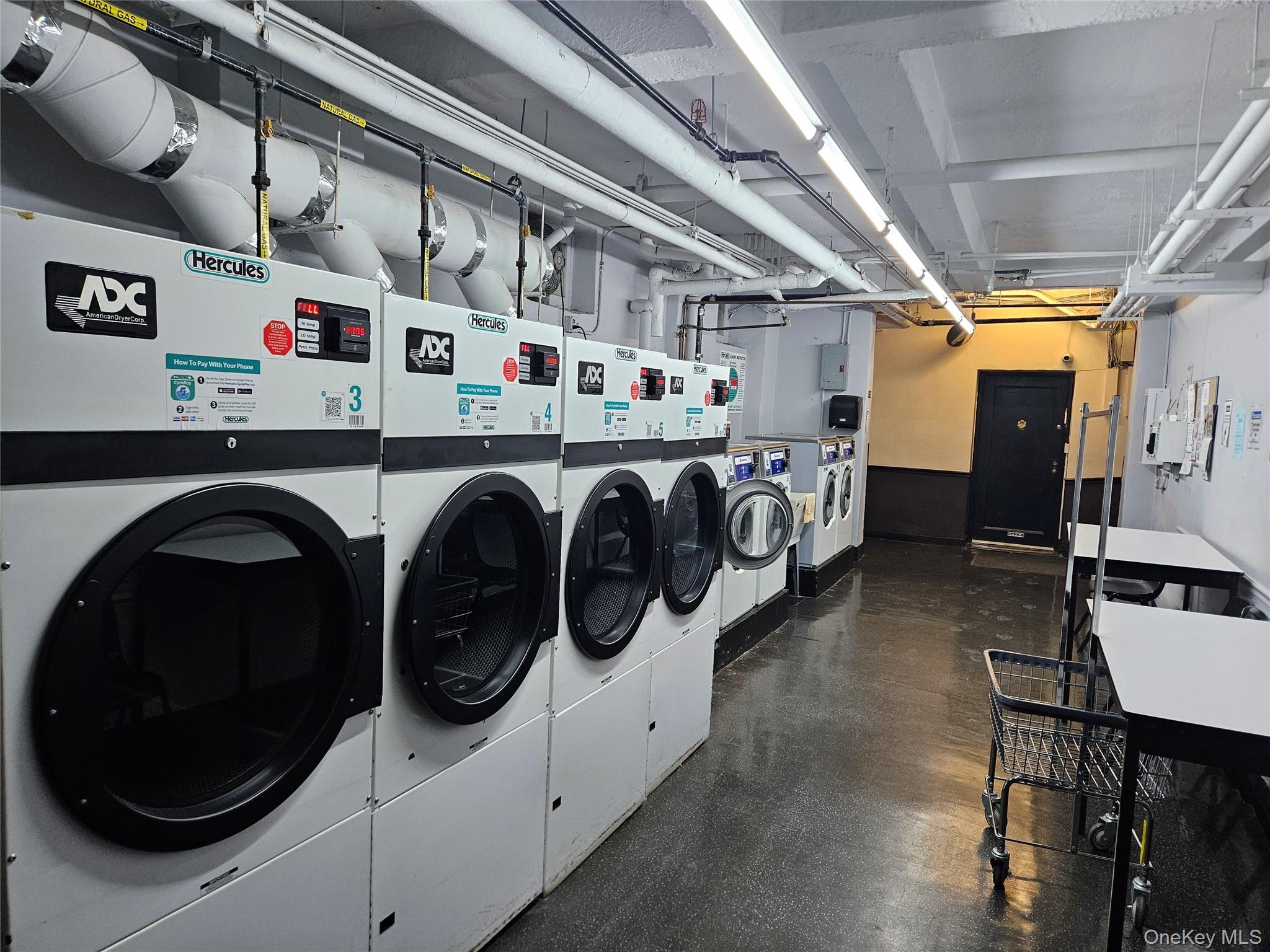 98-25 64th Road, Unit 8F Queens, NY 11374 - Photo 8 of 8 a utility room with dryer and washer