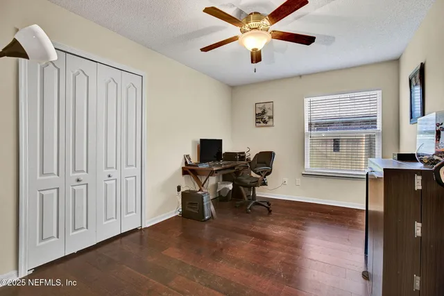 a workspace with chandelier fan and a window
