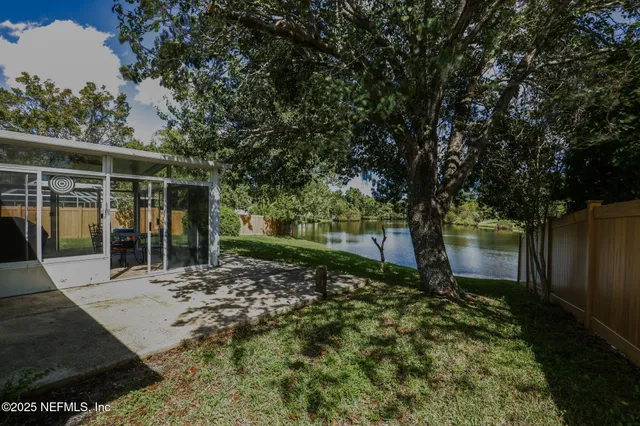 a view of a lake with houses in the background