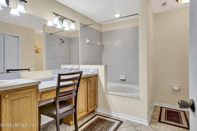 a bathroom with a sink a mirror and a shower