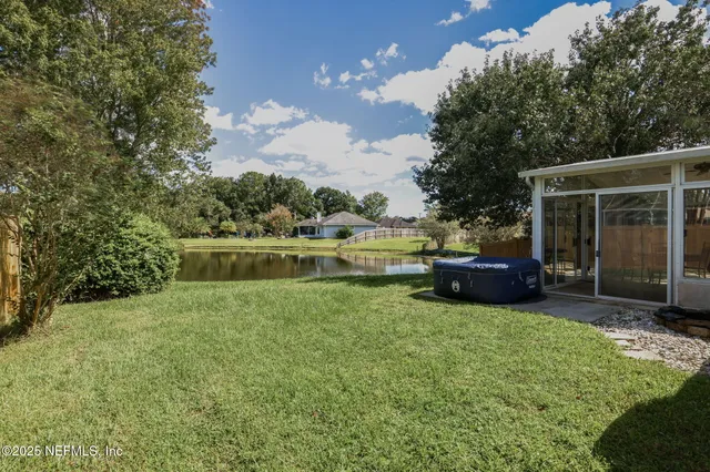 a view of a house with backyard sitting area and garden