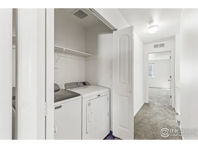 a utility room with cabinets washer and dryer
