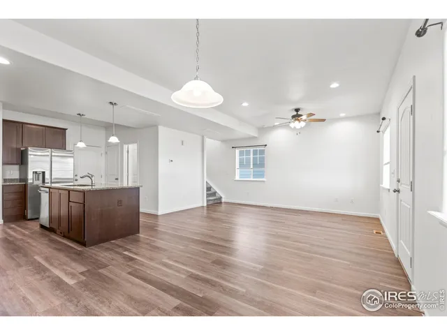 a view of a kitchen and a kitchen with a wooden floor