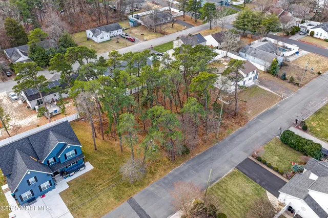 an aerial view of residential houses with outdoor space and swimming pool