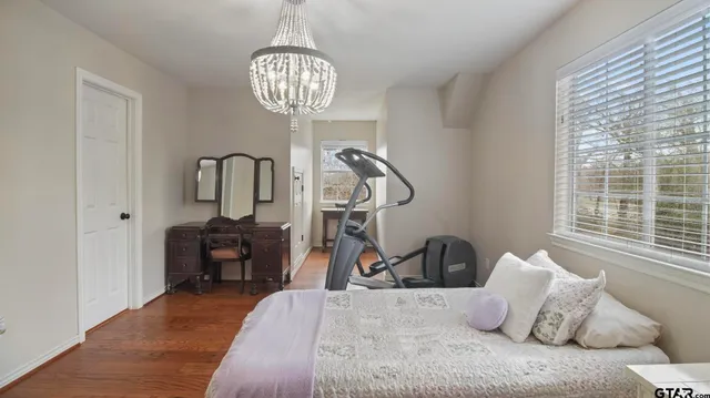 a view of a house with a yard and large trees