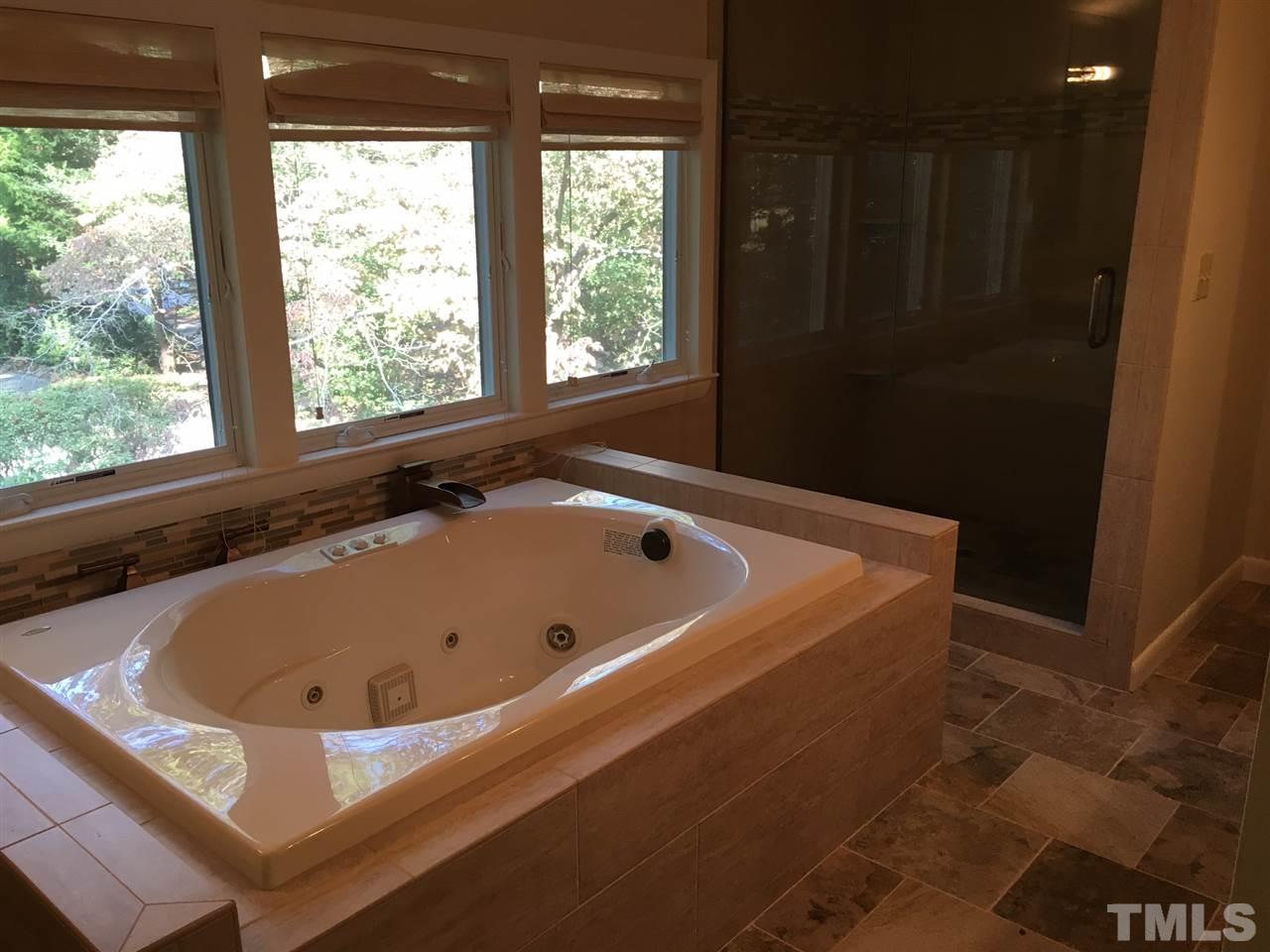 5401 Edington Lane Raleigh, NC 27604 - Photo 14 of 25 a bath tub sitting in a bathroom next to a window