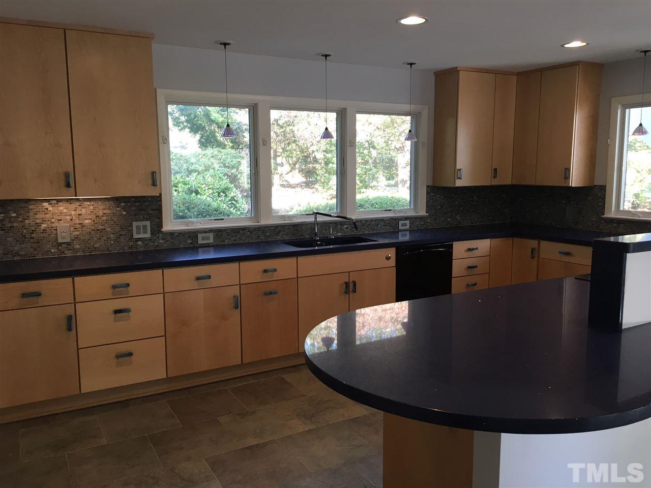 5401 Edington Lane Raleigh, NC 27604 - Photo 7 of 25 a kitchen with stainless steel appliances granite countertop a sink a window and a counter space