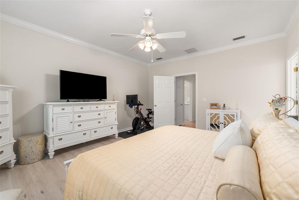 7418 White Oaks Road Alachua, FL 32615 - Photo 19 of 46 a bedroom with a bed and flat screen tv