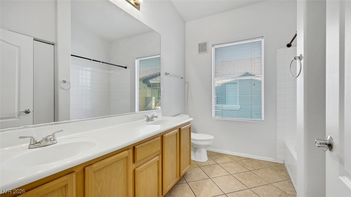2305 West Horizon Ridge Parkway, Unit 1224 Henderson, NV 89052 - Photo 12 of 26 Full bathroom featuring double vanity, light tile patterned floors, and shower combination