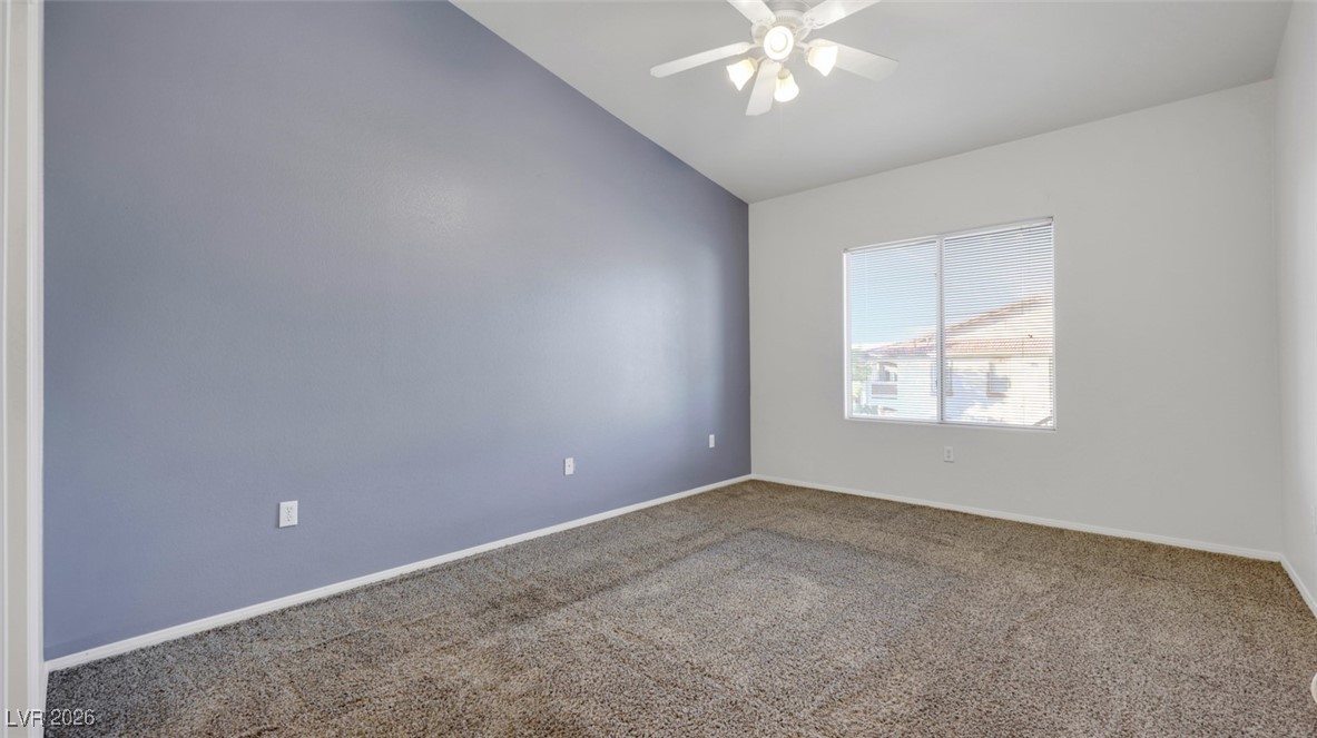 2305 West Horizon Ridge Parkway, Unit 1224 Henderson, NV 89052 - Photo 14 of 26 Carpeted empty room with vaulted ceiling and ceiling fan