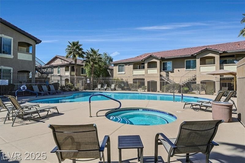 2305 West Horizon Ridge Parkway, Unit 1224 Henderson, NV 89052 - Photo 24 of 26 Community pool with a community hot tub, a patio area, and a residential view