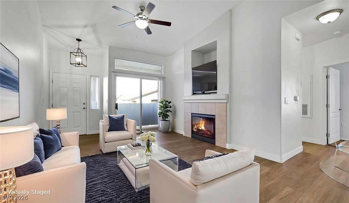 2305 West Horizon Ridge Parkway, Unit 1224 Henderson, NV 89052 - Photo 3 of 26 Virtually Staged - Living area with wood finished floors, a fireplace, and ceiling fan