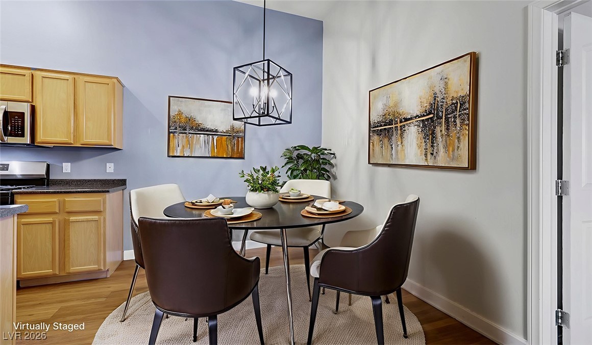 2305 West Horizon Ridge Parkway, Unit 1224 Henderson, NV 89052 - Photo 6 of 26 Virtually Staged - Dining area with light wood finished floors and a chandelier