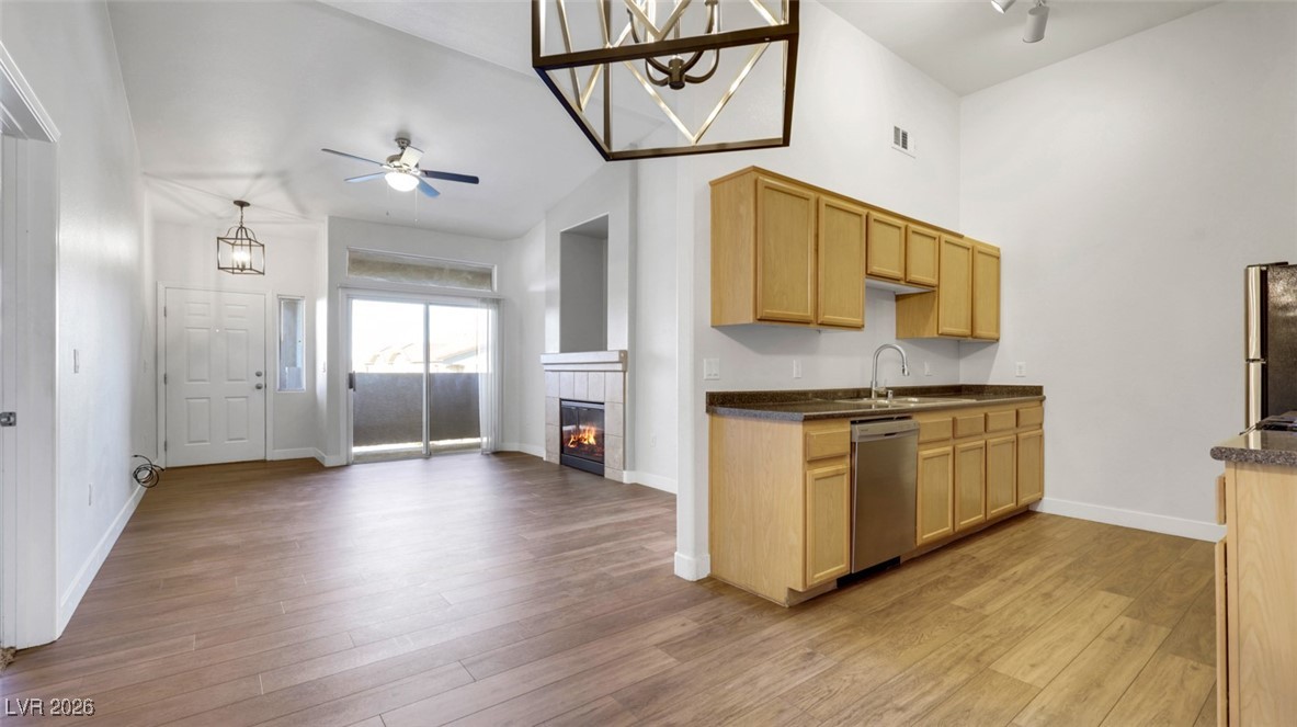 2305 West Horizon Ridge Parkway, Unit 1224 Henderson, NV 89052 - Photo 7 of 26 Kitchen featuring ceiling fan, a fireplace, light wood-type flooring, and appliances with stainless steel finishes
