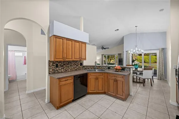 a kitchen with stainless steel appliances a sink a stove a refrigerator and cabinets