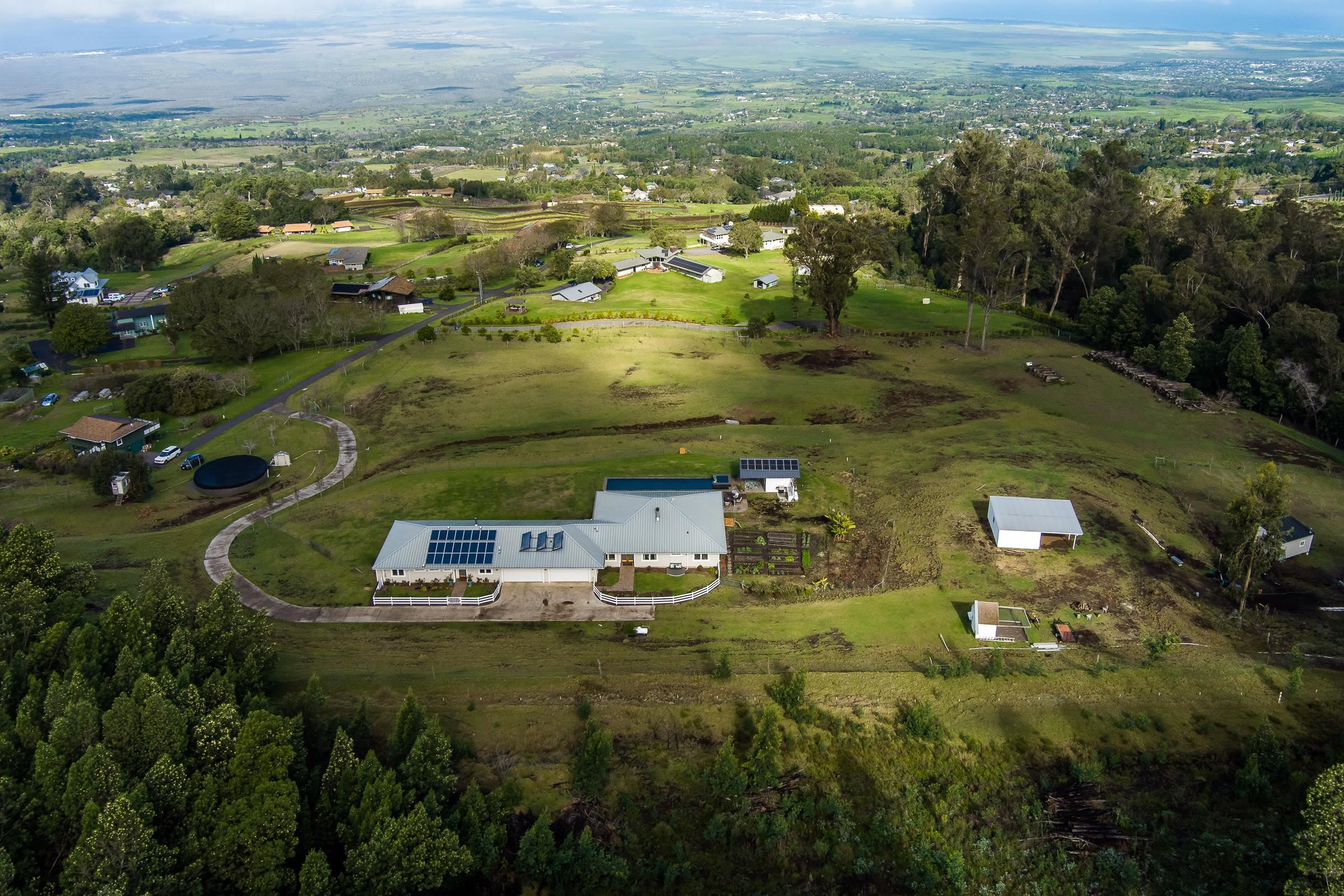 569 Hapapa Road Kula, HI 96790 - Photo 14 of 50 Left to Right: Treehouse, Catchment Water Storage, Home, Pool house, Chicken coop, Barn and Honey Processing Shed.