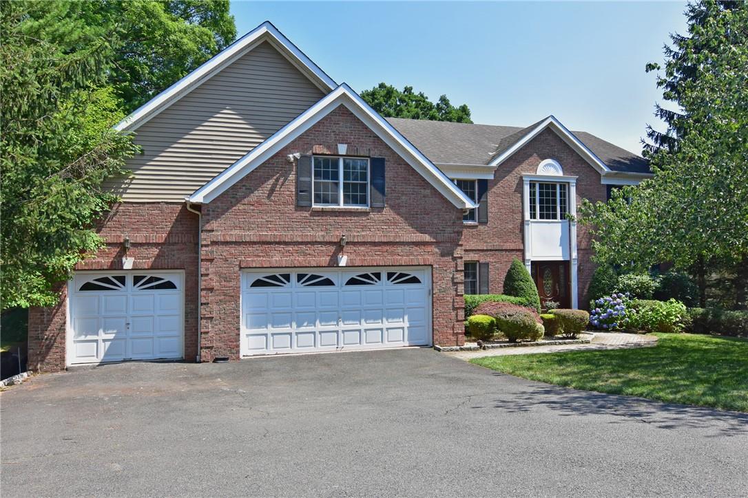 a view of a house with a yard and garage
