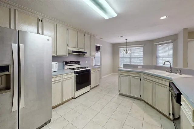 a view of a kitchen with a sink and cabinet