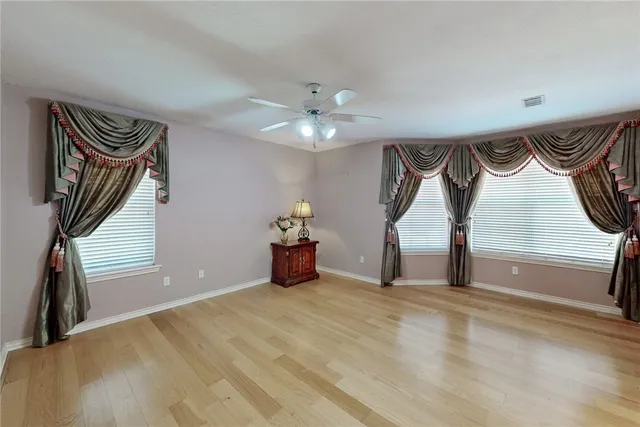 a view of a room with a large windows and chandelier
