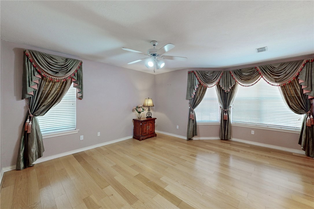 5901 Sheffield Terrace Lane Bryan, TX 77802 - Photo 14 of 31 Large, open feel with plethora of windows allowing natural light, crown molding, ceiling fan with light fixture