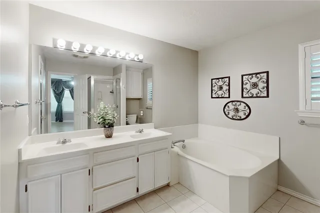 a view of an empty room with a window and chandelier